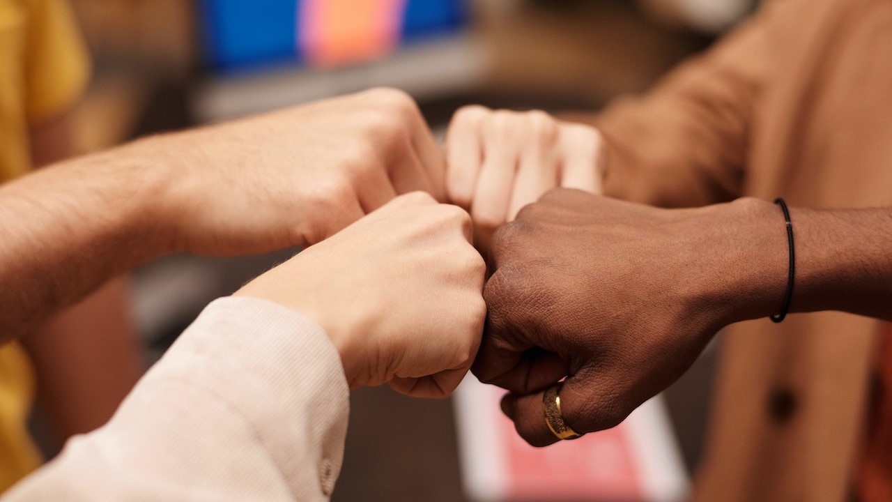 Group of People with Their Fists Together | Goodwill Car Donations