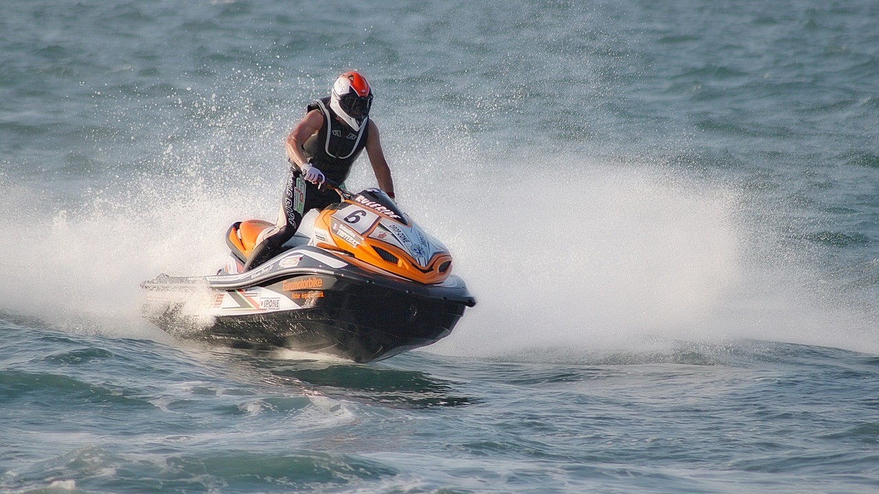 Man riding a yellow jetski | Goodwill Car Donations