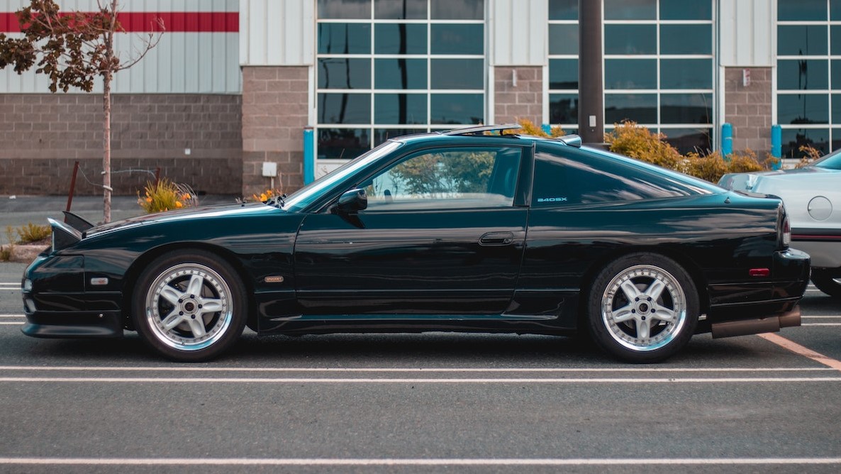 Modern black car parked on edge of road | Goodwill Car Donations