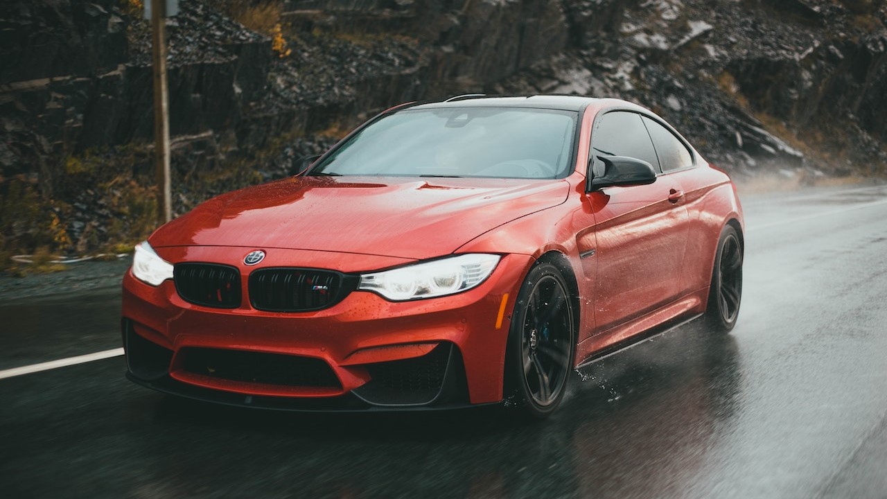 Orange Car On Wet Road | Goodwill Car Donations