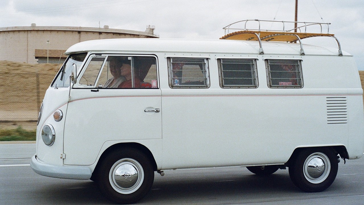 People riding white volkswagen van | Goodwill Car Donations