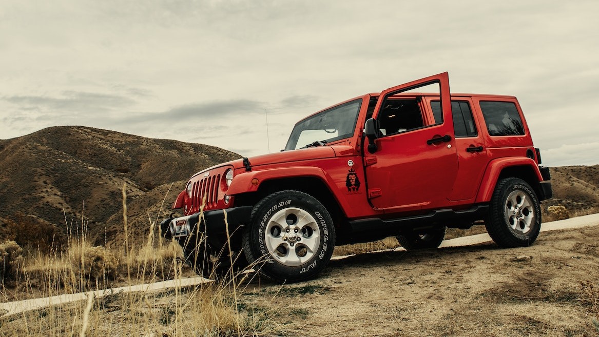 Photo of Red SUV On Dirt Road | Goodwill Car Donations