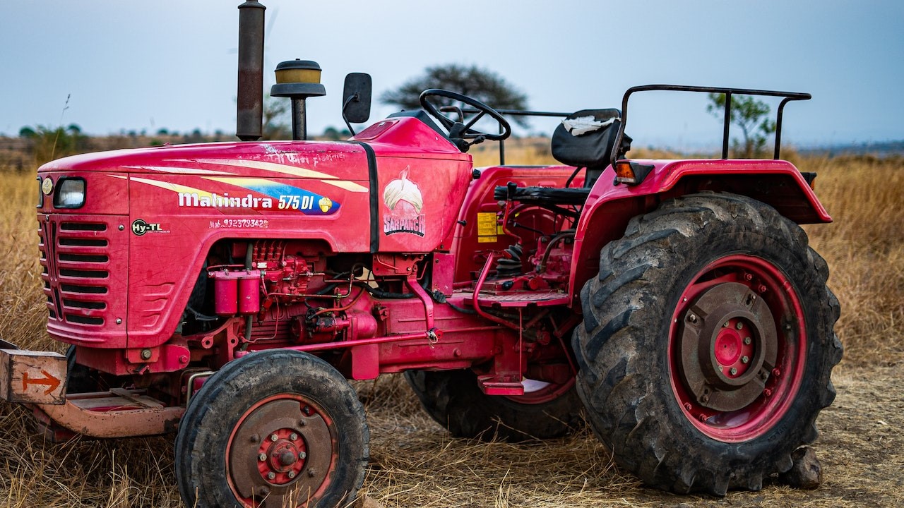 Red Tractor on a Grassy Field | Goodwill Car Donations