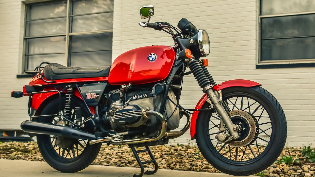 Red and Black Motorcycle Parked Beside the Building | Goodwill Car Donations