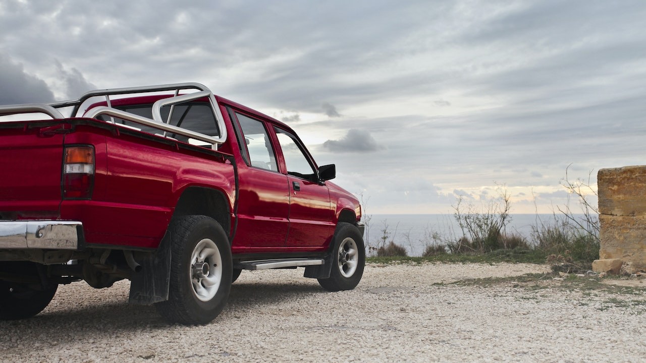 Red pick up truck parked on dirt | Goodwill Car Donations