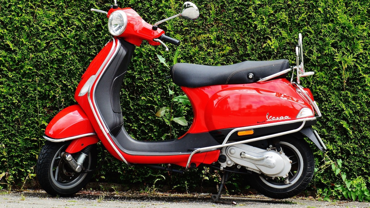 Red scooter parked | Goodwill Car Donations