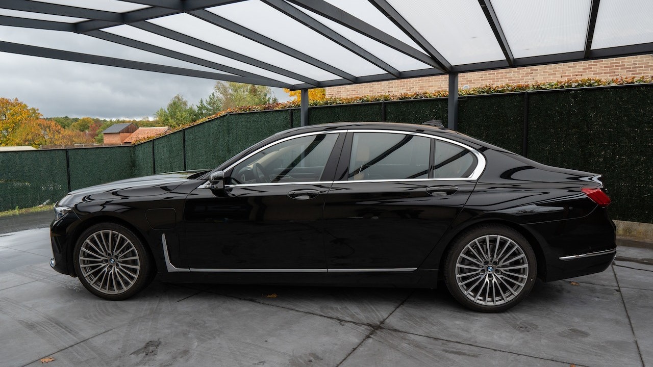 Side view of a black car parked in a garage | Goodwill Car Donations