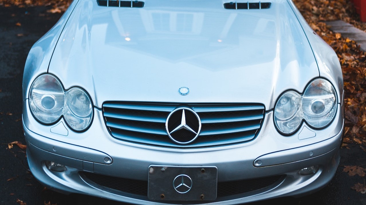 Silver Mercedes Benz Car Parked Near White and Red Building | Goodwill Car Donations