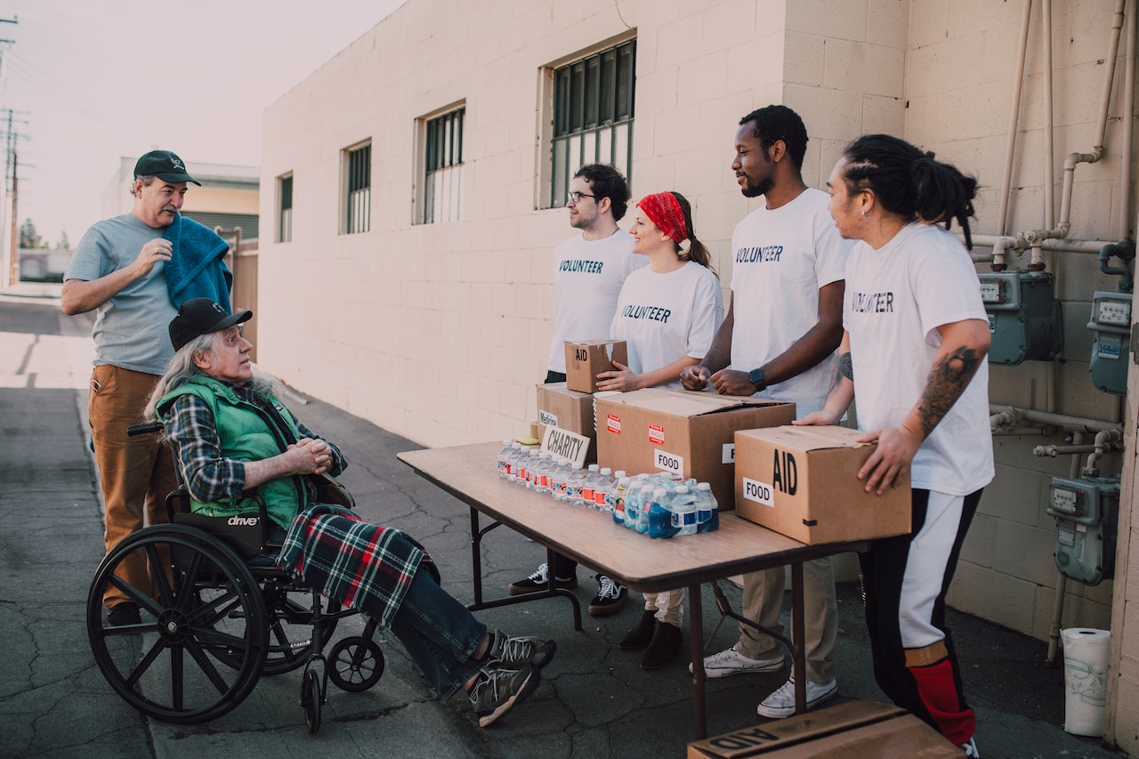 Volunteers Assisting an Old Man | Goodwill Car Donations