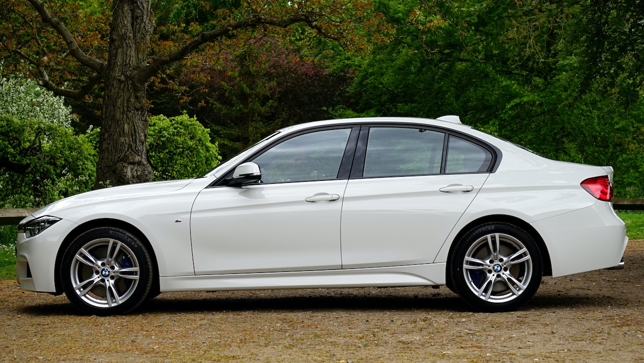 White Bmw Sedan Parked Beside Tree | Goodwill Car Donations