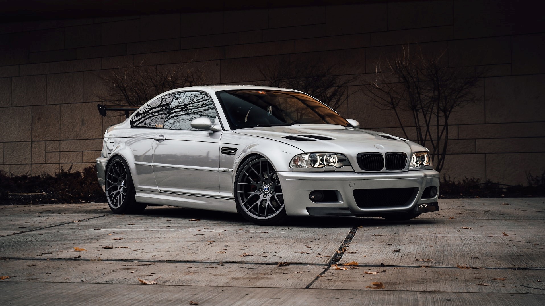 White bmw m3 coupe parked beside orange wall | Goodwill Car Donations