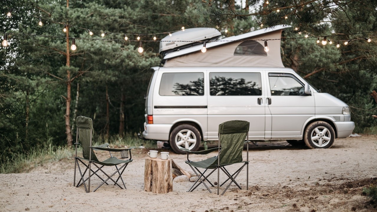 White camper van with two chairs | Goodwill Car Donations