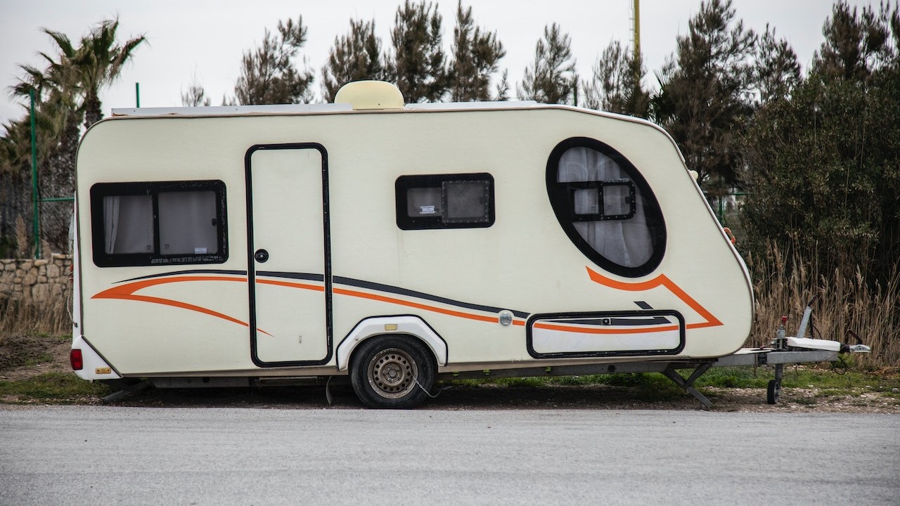 White trailer with orange lining parked | Goodwill Car Donations