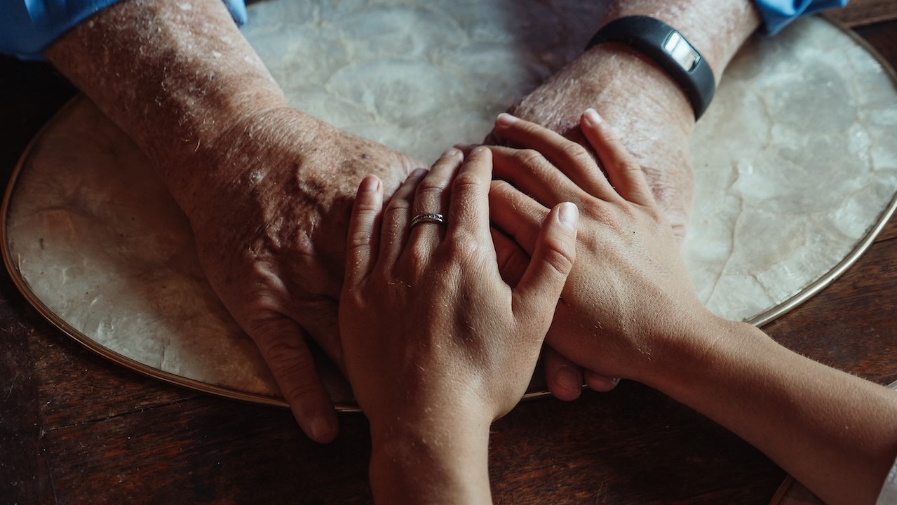 A Close-Up Shot of People Holding Hands | Goodwill Car Donations