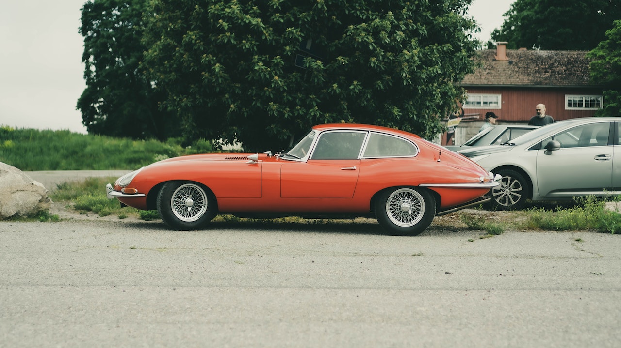 A Red Vintage Car Parked on the Street | Goodwill Car Donations