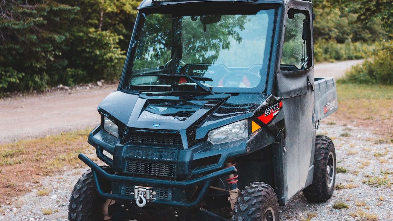 ATV on shabby pathway behind green trees | Goodwill Car Donations Donations