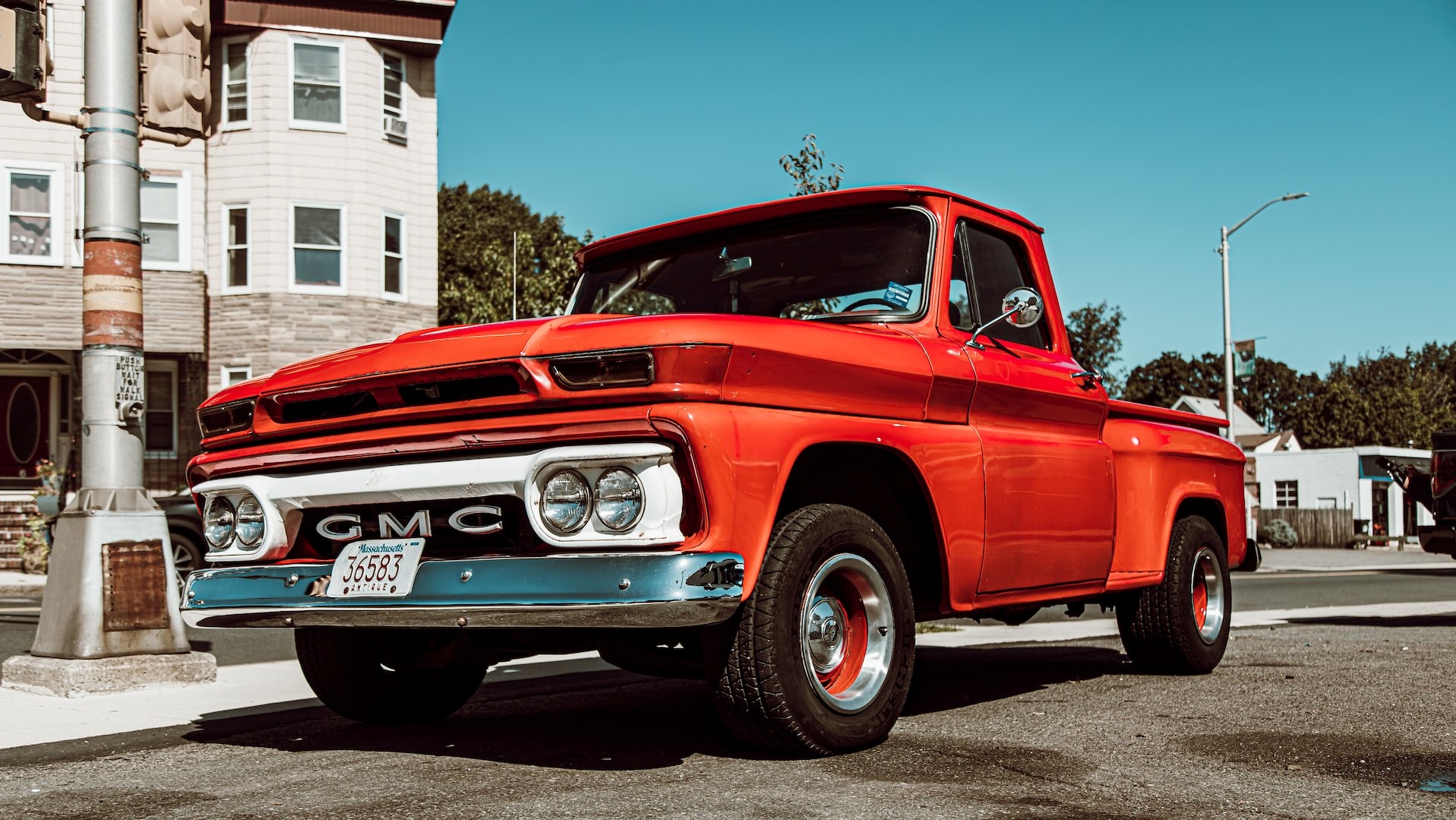 Classic red GMC single cab pick up truck on road photo | Goodwill Car Donations
