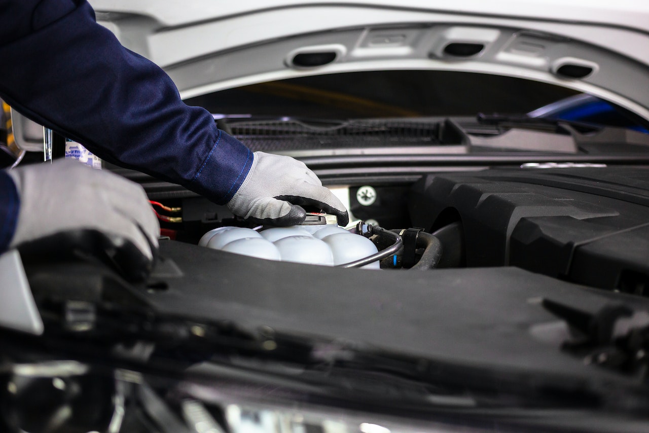 Close-up of Mechanic Holding the Engine | Goodwill Car Donations