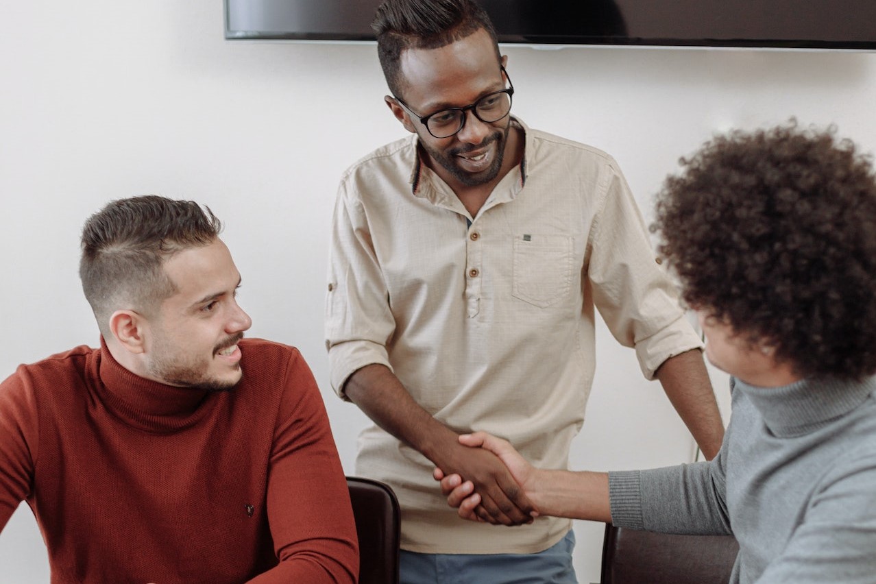 Men Doing Hand Shake with Colleagues | Goodwill Car Donations