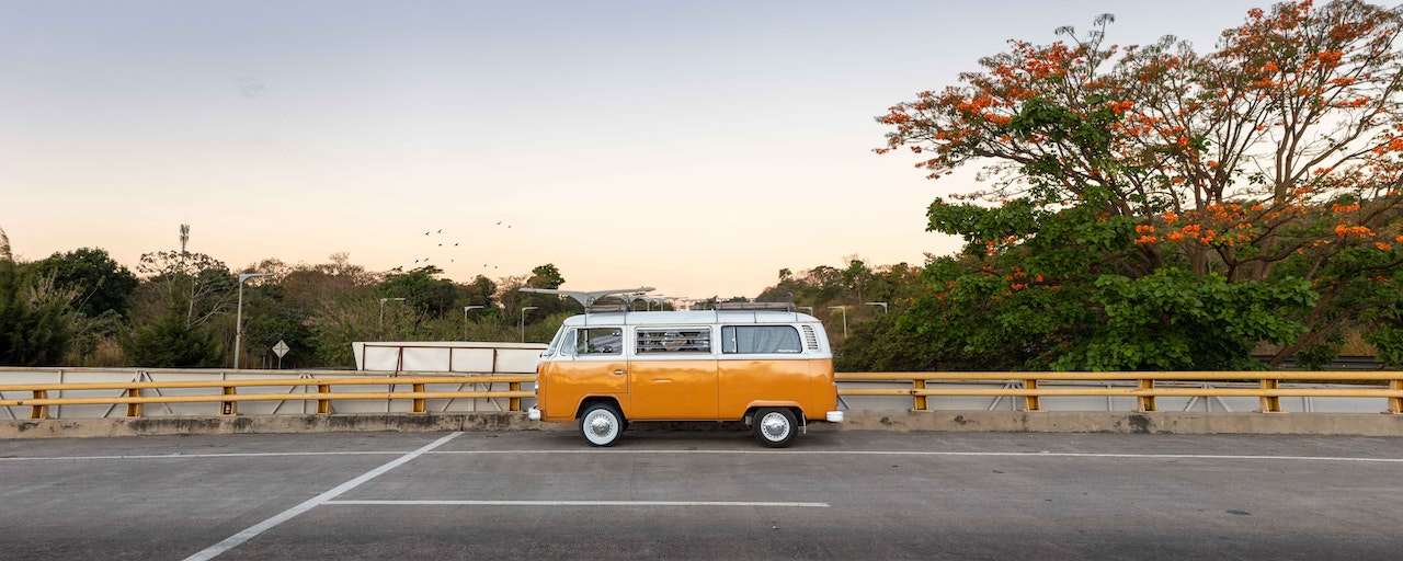 Orange and White Volkswagen Bus on Road | Goodwill Car Donations