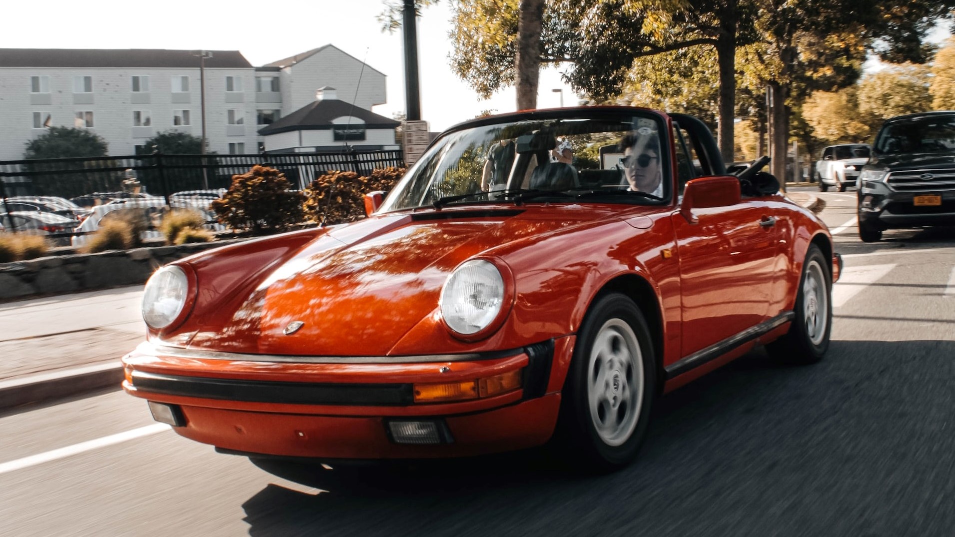 Red porsche on road | Goodwill Car Donations