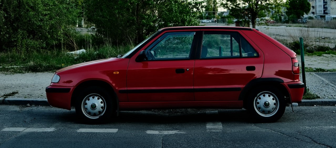 Side View of a Parked Red Car | Goodwill Car Donations