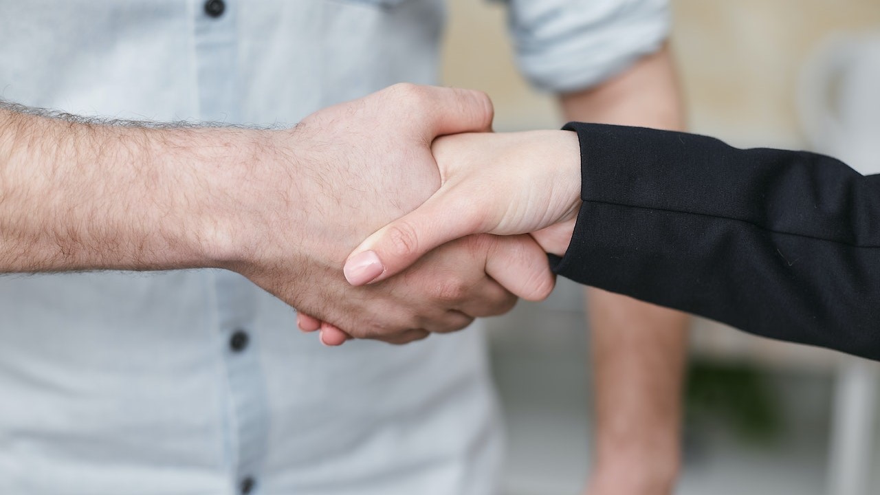 Two People Shaking their Hands | Goodwill Car Donations