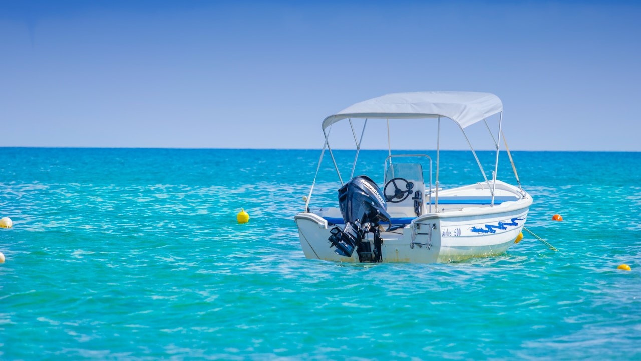 White Bow Rider Parked on the Body of Water | Goodwill Car Doanations