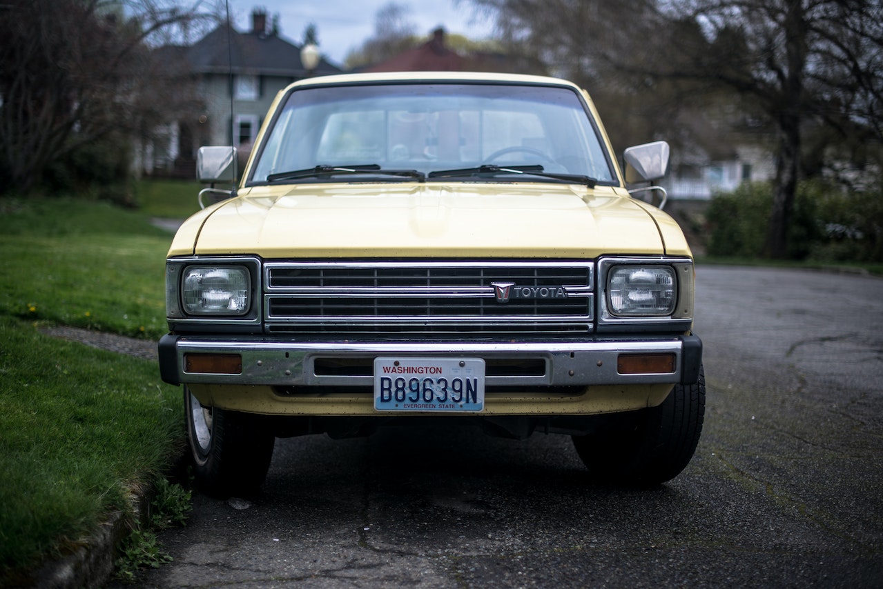 Yellow Toyota Vehicle on Concrete Road | Goodwill Car Donations