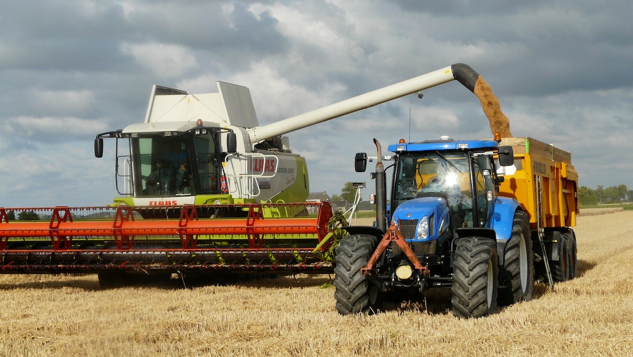 Blue Tractor Next to White Farm Vehicle at Daytime | Goodwill Car Donations