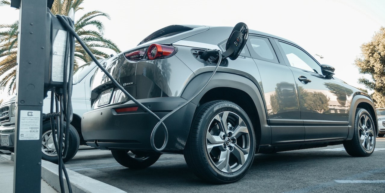 Gray Electric Car Parked on a Charging Bay | Goodwill Car Donations