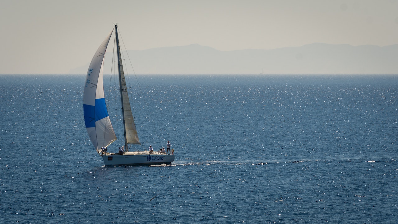 White and Blue Sailboat on Sea | Goodwill Car Donations