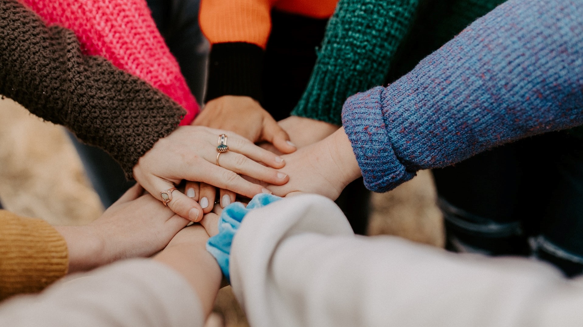 girl friends hands piled together | Goodwill Car Donations