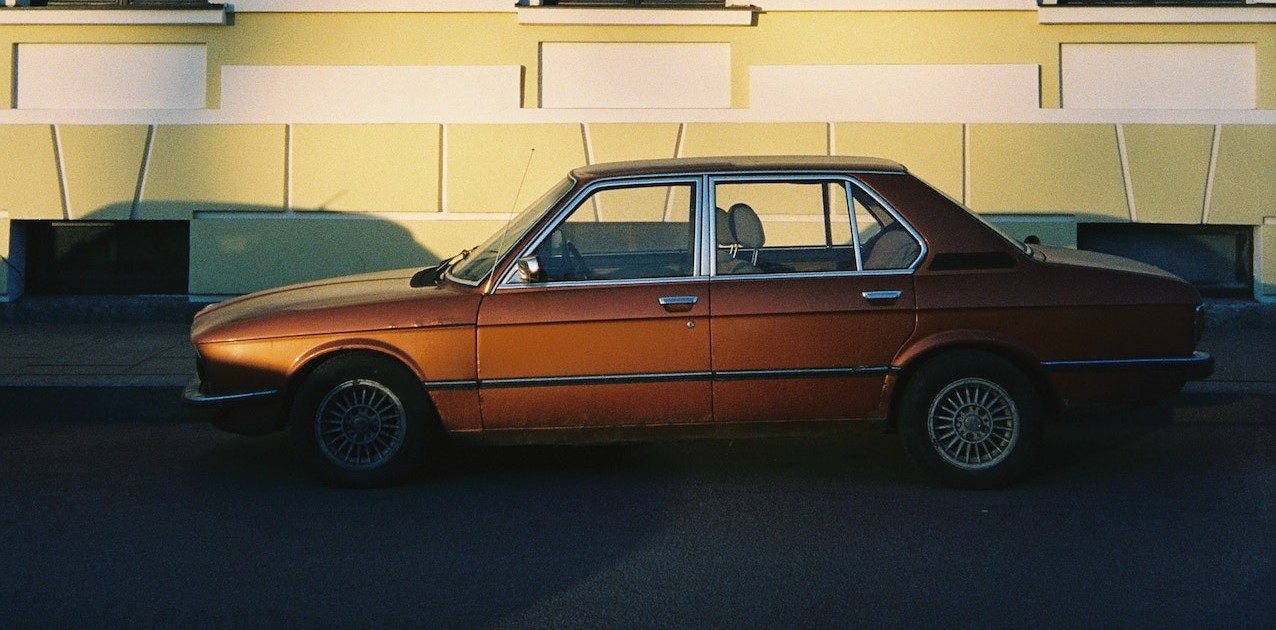 A Brown Vintage Car beside a Building | Goodwill Car Donations