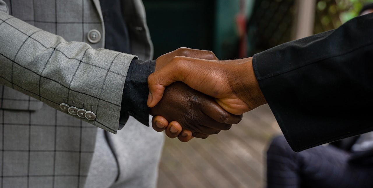 Men in Suit Jackets Shaking Hands | Goodwill Car Donations