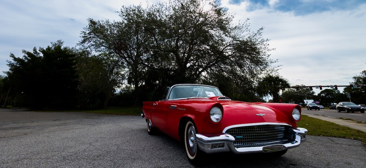 Red and Silver Car Parked near Green Trees | Goodwill Car Donations