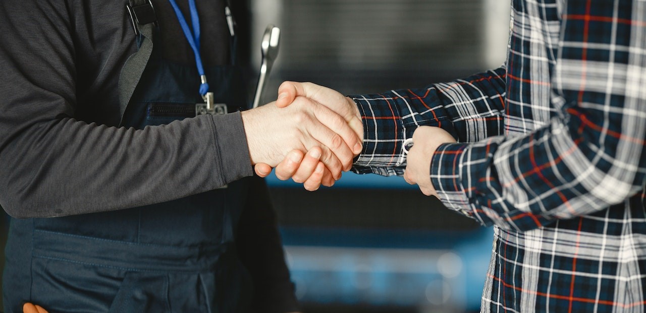 Shaking Hands with a Man in Working Uniform | Goodwill Car Donations