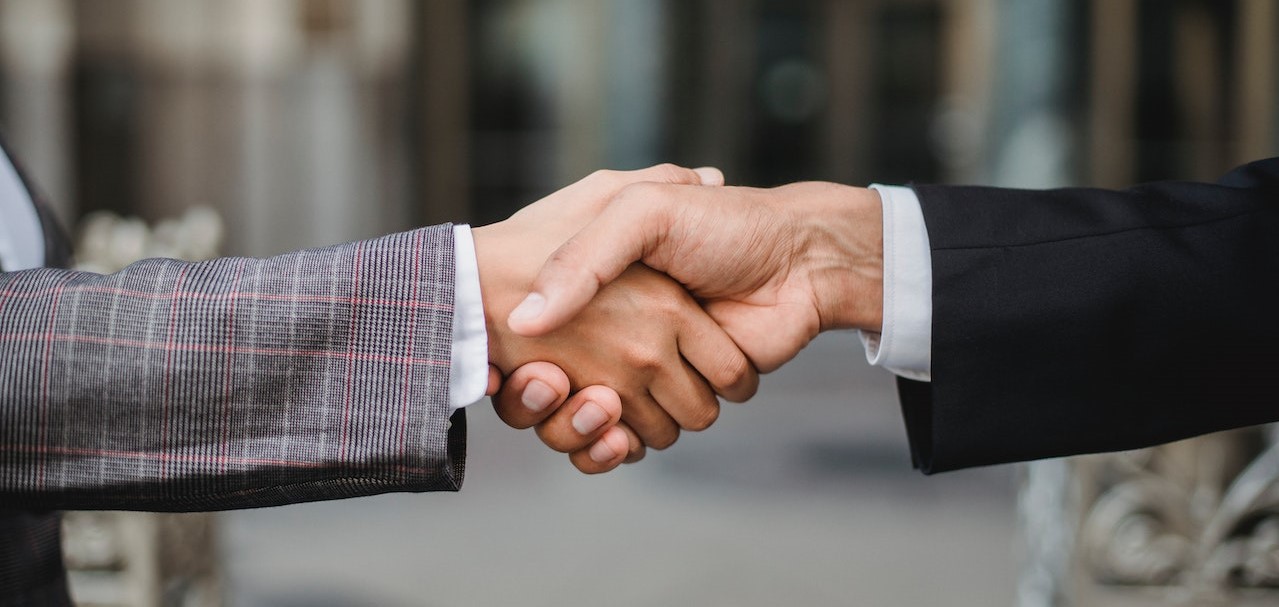 Two People Shaking Hands | Goodwill Car Donations