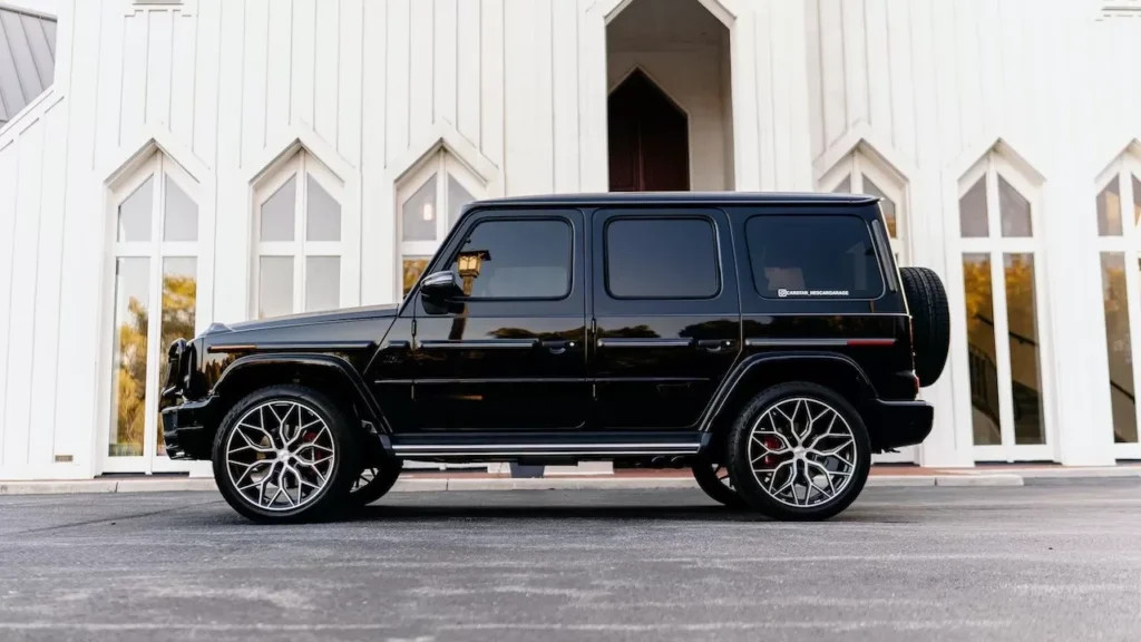 A sleek black SUV parked outside a stylish white building with geometric windows