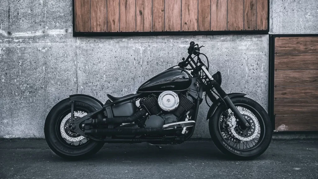 A black motorcycle parked in front of a building