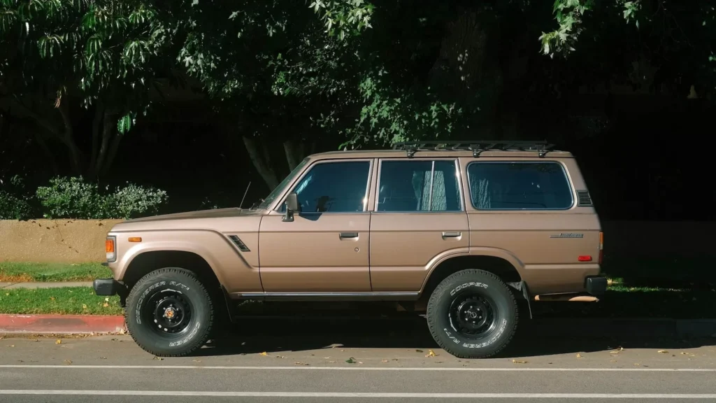 A brown suv parked on the side of the road