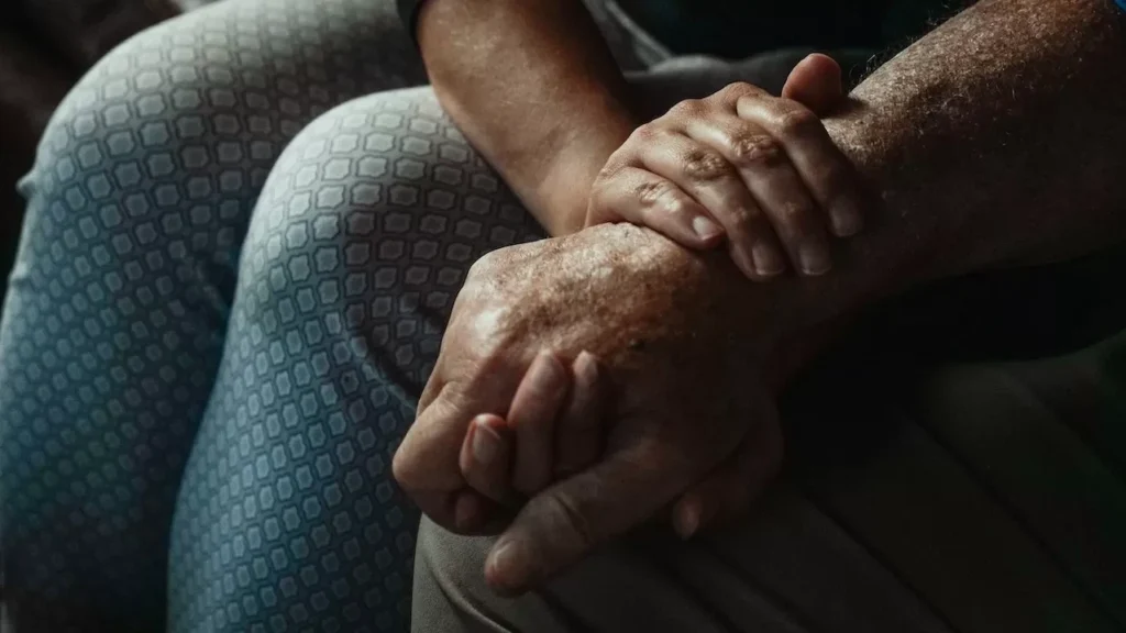 A close-up of hands conveying support and compassion in an intimate moment.