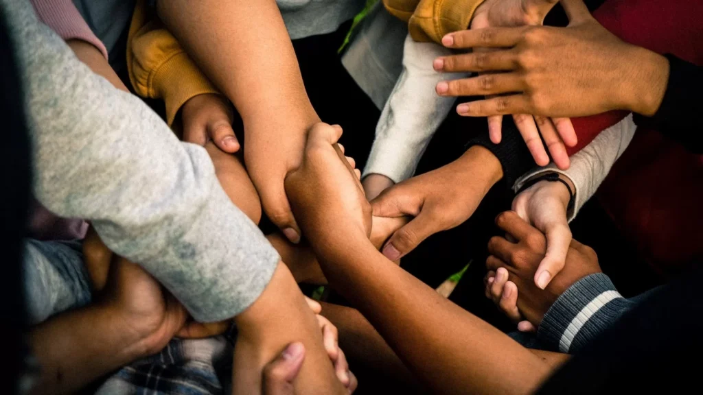 a group of people holding hands