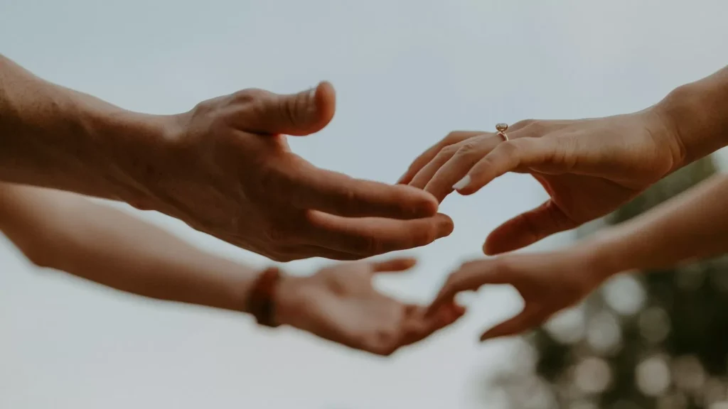 A group of people reaching out their hands