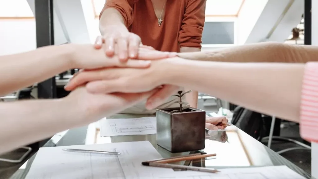 Group of professionals collaborate during a planning meeting indoors, showcasing teamwork and leadership.