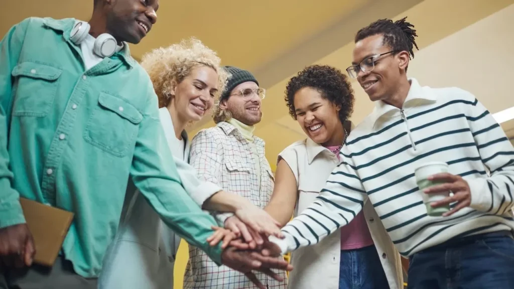 A diverse group of adults sharing a joyful team-building moment indoors