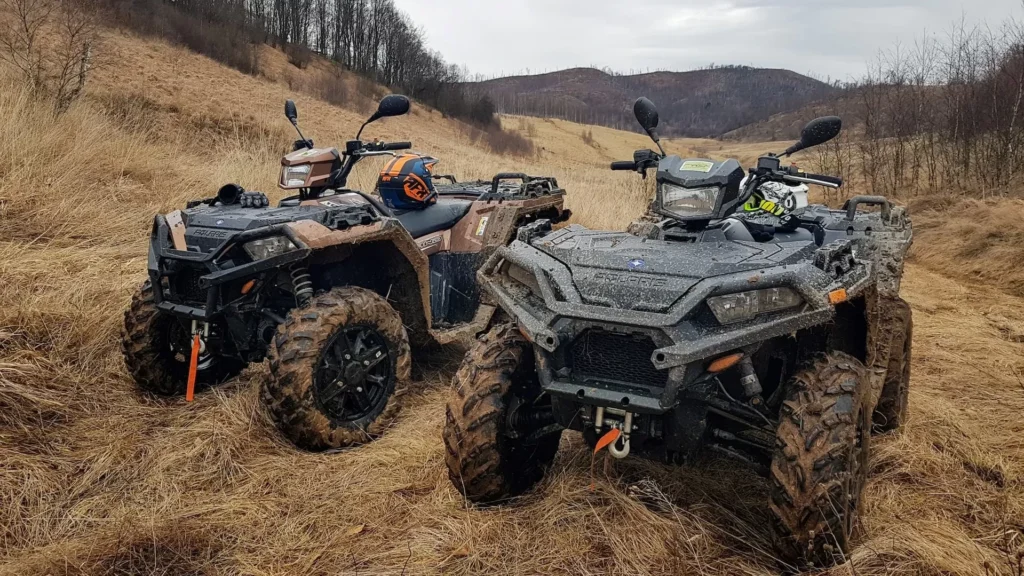 Black and gray ATV on brown field during daytime
