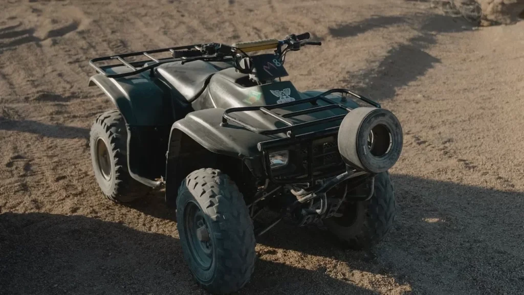 ATV parked in a remote desert area with rocky hills, perfect for off-road adventure