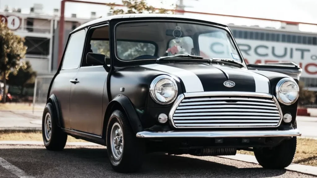 A vintage Mini Cooper parked outdoors at the Circuit of the Americas track