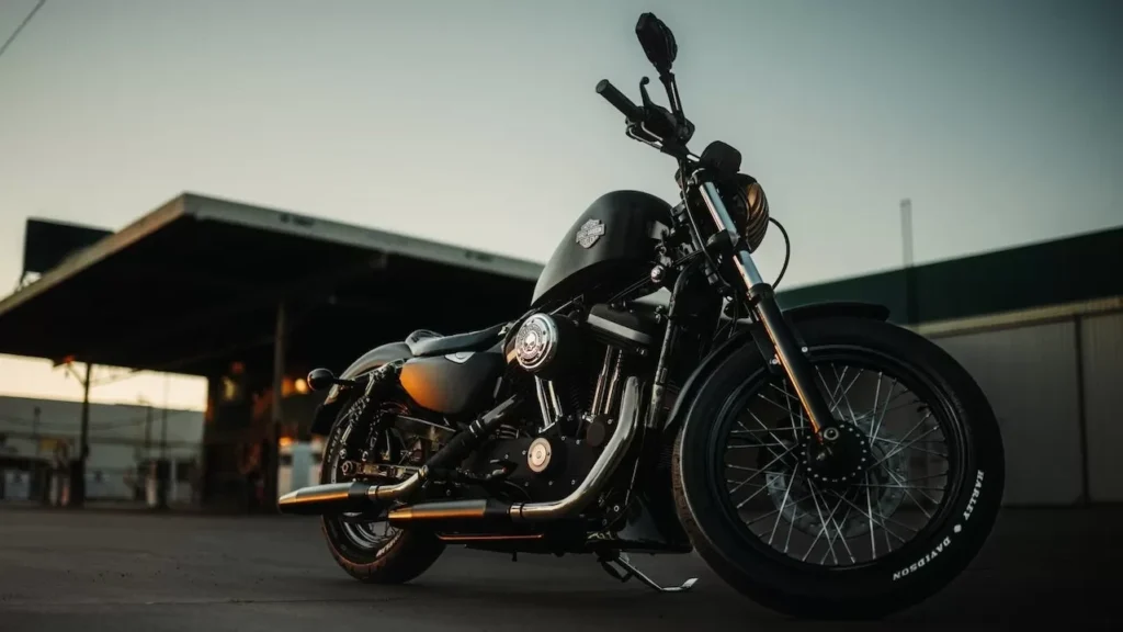 A sleek black motorcycle parked outdoors during sunset, capturing an adventurous vibe.
